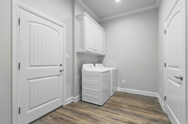 1011 Cardinal Cv, Graford, TX 76449 - clothes washing area featuring washing machine and clothes dryer, ornamental molding, cabinet space, dark wood-style flooring, and baseboards