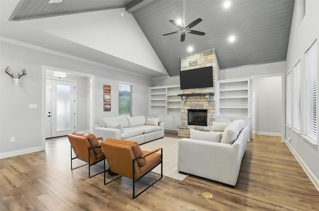 1011 Cardinal Cv, Graford, TX 76449 - living area featuring high vaulted ceiling, a stone fireplace, ceiling fan, wood finished floors, and baseboards