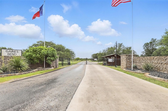 1011 Cardinal Cv, Graford, TX 76449 - view of concrete street with a gate and a gated entry
