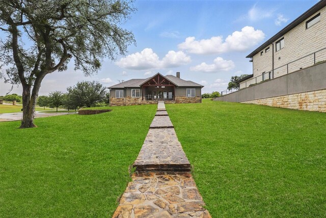 1011 Cardinal Cv, Graford, TX 76449 - view of front facade with a front lawn and stone siding