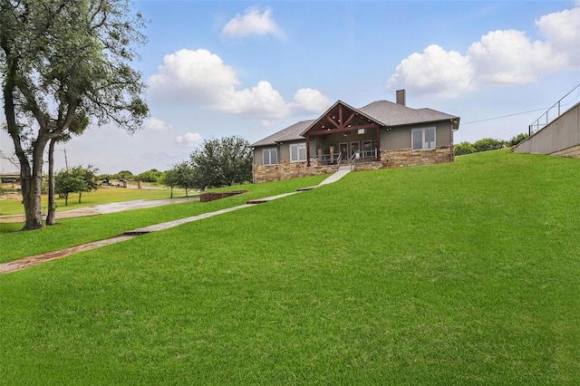 1011 Cardinal Cv, Graford, TX 76449 - view of front facade with a porch, a chimney, a front lawn, and stone siding
