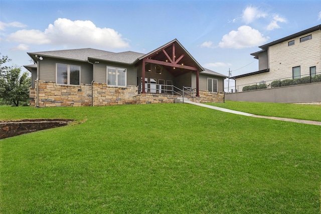 1011 Cardinal Cv, Graford, TX 76449 - rear view of house featuring stone siding, a yard, and a shingled roof
