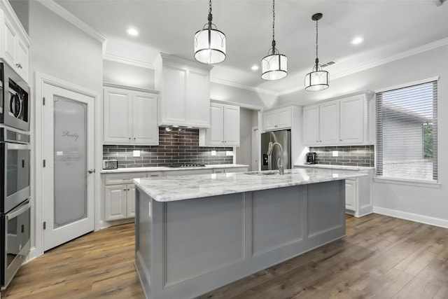 1011 Cardinal Cv, Graford, TX 76449 - kitchen featuring white cabinetry, appliances with stainless steel finishes, decorative backsplash, dark wood-style floors, and crown molding