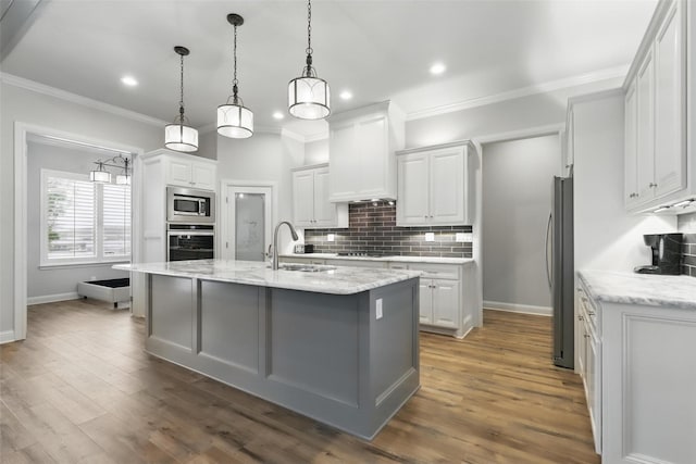 1011 Cardinal Cv, Graford, TX 76449 - kitchen with stainless steel appliances, backsplash, a sink, white cabinetry, and recessed lighting
