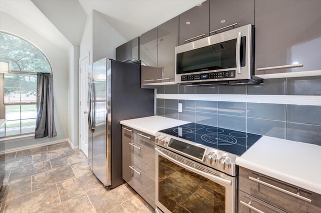 4405 Westcliffe Dr, Mansfield, TX 76063 - kitchen with light countertops, lofted ceiling, stainless steel appliances, decorative backsplash, and modern cabinets