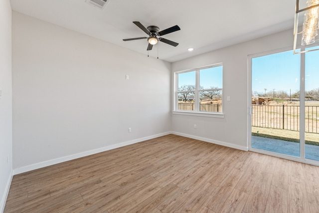 spare room with a ceiling fan, light wood-type flooring, baseboards, visible vents, and recessed lighting