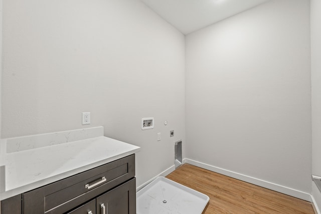 laundry area featuring electric dryer hookup, light wood-type flooring, baseboards, cabinet space, and hookup for a washing machine