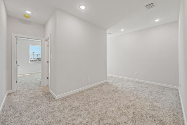 carpeted empty room with recessed lighting, baseboards, and visible vents