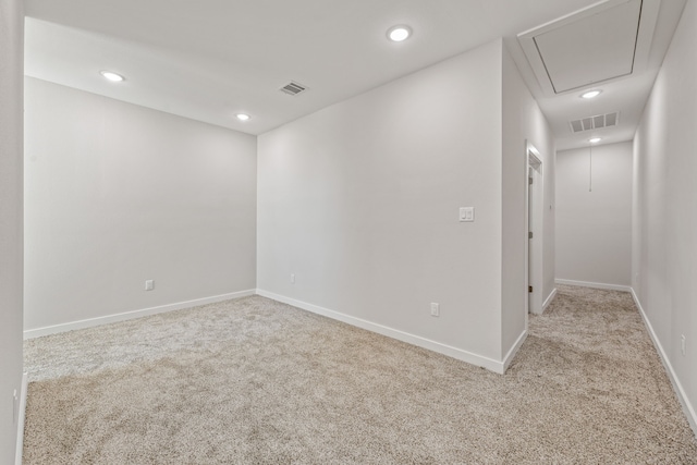 carpeted empty room featuring recessed lighting, baseboards, attic access, and visible vents