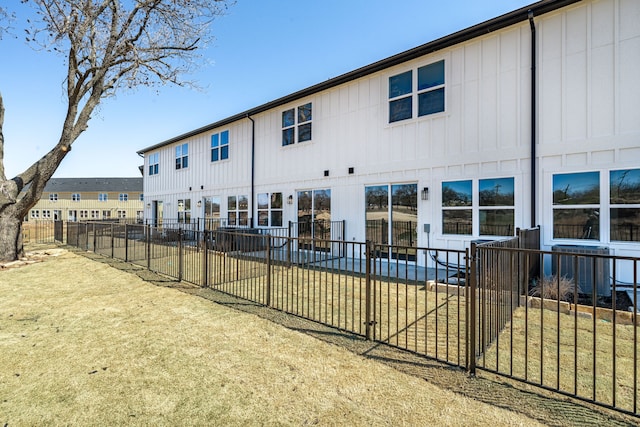 back of property featuring fence and a patio area