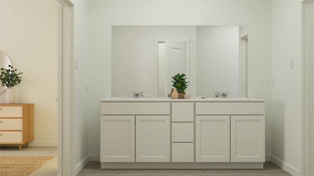 bathroom with baseboards, double vanity, and a sink