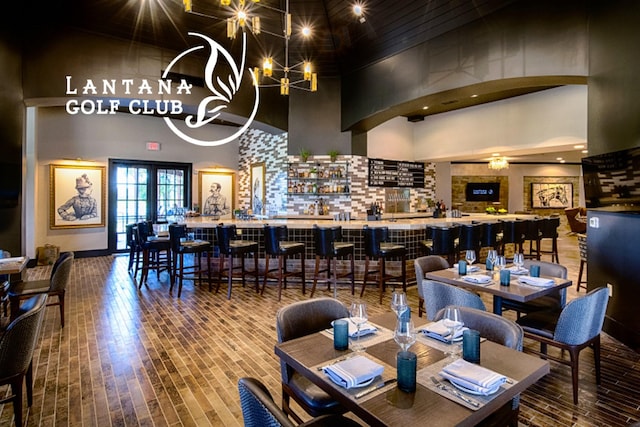 1431 Bonham Pkwy, Lantana, TX 76226 - dining area featuring a towering ceiling, wood finished floors, and a chandelier