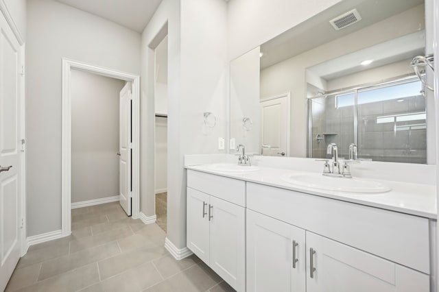 709 Caraway Dr, Princeton, TX 75071 - full bathroom with a stall shower, double vanity, a walk in closet, tile patterned flooring, and baseboards