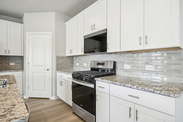 709 Caraway Dr, Princeton, TX 75071 - kitchen featuring stainless steel gas range oven, white cabinetry, backsplash, and light wood-style floors