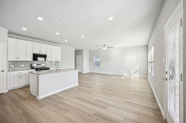 709 Caraway Dr, Princeton, TX 75071 - kitchen with black microwave, stainless steel range with gas cooktop, healthy amount of natural light, a sink, and recessed lighting