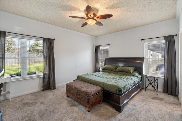 bedroom featuring carpet flooring, multiple windows, ceiling fan, and a textured ceiling