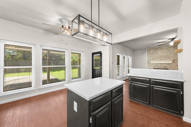 1403 Derby Dr, Kennedale, TX 76060 - kitchen featuring a ceiling fan, dark cabinetry, open floor plan, dark wood-style floors, and a kitchen island