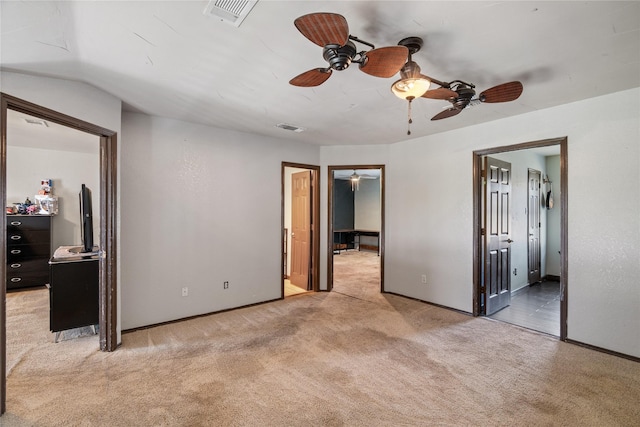 bedroom with baseboards, ceiling fan, visible vents, and light carpet