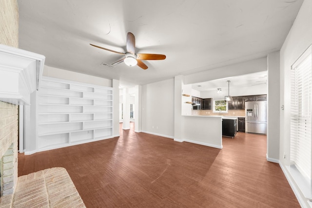 1403 Derby Dr, Kennedale, TX 76060 - unfurnished living room featuring ceiling fan, wood finished floors, a fireplace, and built in features