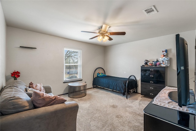 bedroom with light colored carpet, visible vents, and ceiling fan