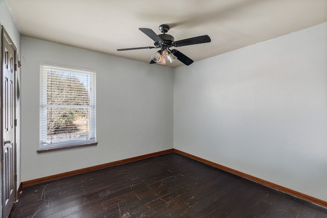 empty room with a ceiling fan, dark wood-style floors, and baseboards