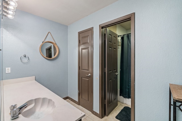 bathroom featuring a shower with curtain, tile patterned floors, and vanity