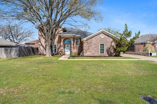 view of front facade with concrete driveway, fence, a front lawn, brick siding, and a chimney