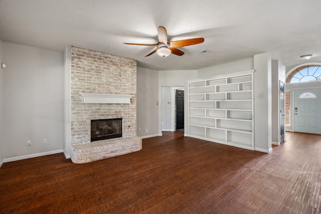 unfurnished living room featuring wood finished floors, baseboards, and ceiling fan