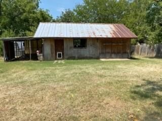 view of outbuilding with an outbuilding and fence