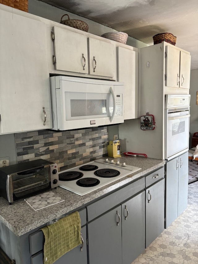 8947 Adams Cir, Cresson, TX 76035 - kitchen with white appliances, light countertops, a toaster, and backsplash