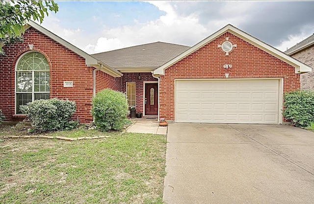 8729 Shavano Dr, Fort Worth, TX 76123 - view of front of house with brick siding, a garage, driveway, and a front lawn