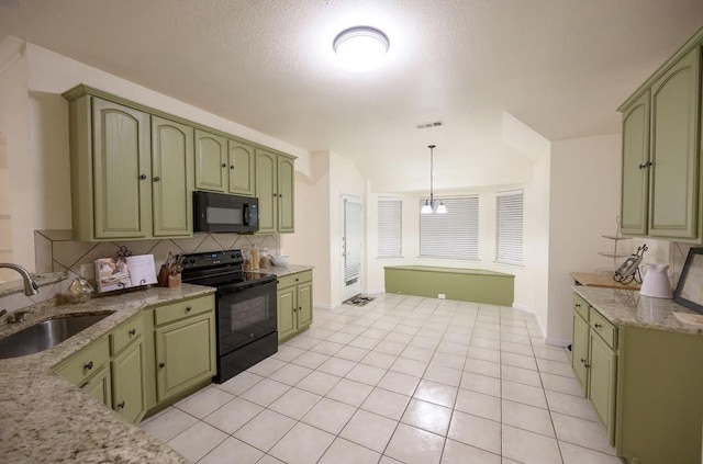 8729 Shavano Dr, Fort Worth, TX 76123 - kitchen with green cabinets, black appliances, a sink, and light stone counters