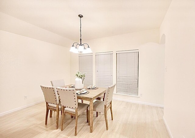 8729 Shavano Dr, Fort Worth, TX 76123 - dining space featuring arched walkways, light wood-style flooring, a ceiling fan, and a chandelier