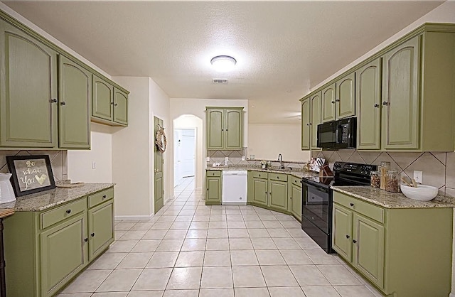 8729 Shavano Dr, Fort Worth, TX 76123 - kitchen featuring green cabinetry, black appliances, and a textured ceiling