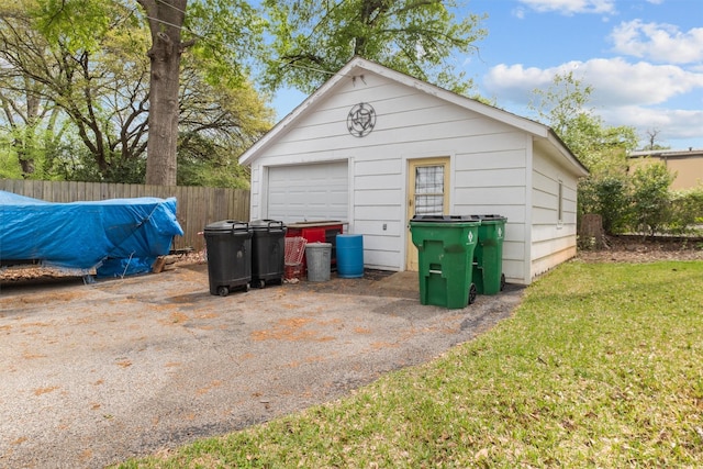 detached garage featuring fence