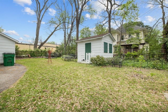 view of yard with fence and an outbuilding