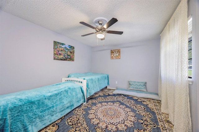 11311 Audelia Rd Unit 214, Dallas, TX 75243 - carpeted bedroom featuring a textured ceiling and ceiling fan
