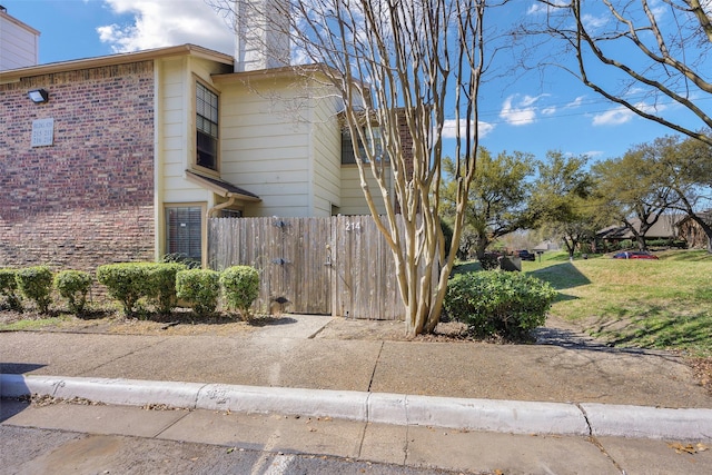 11311 Audelia Rd Unit 214, Dallas, TX 75243 - view of side of property with fence, a chimney, a yard, and brick siding