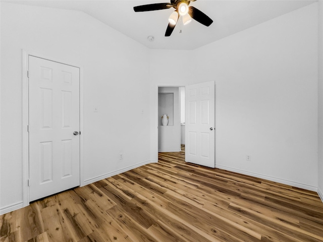 4512 Stepping Stone Dr, Fort Worth, TX 76123 - unfurnished bedroom with baseboards, wood finished floors, and vaulted ceiling