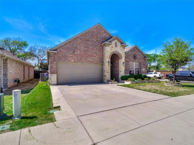 view of front of home with central AC unit, a front yard, brick siding, and concrete driveway