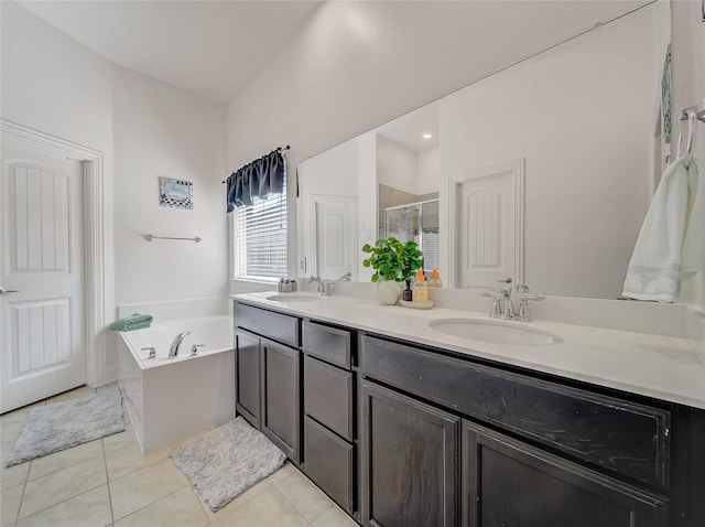 full bath featuring double vanity, a sink, tile patterned floors, and a shower stall