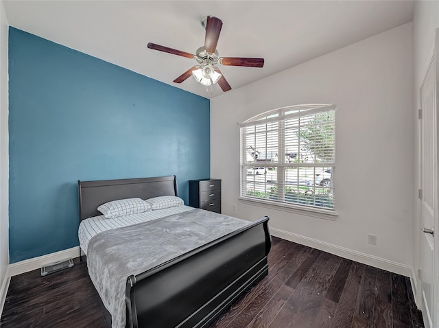 bedroom with baseboards, a ceiling fan, and dark wood finished floors