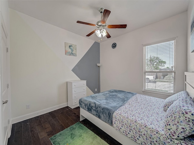 bedroom with baseboards, dark wood-style flooring, and ceiling fan