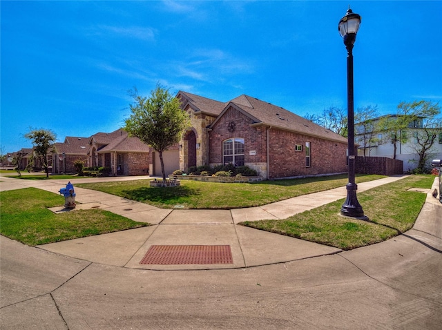 view of front of house with brick siding and a front yard