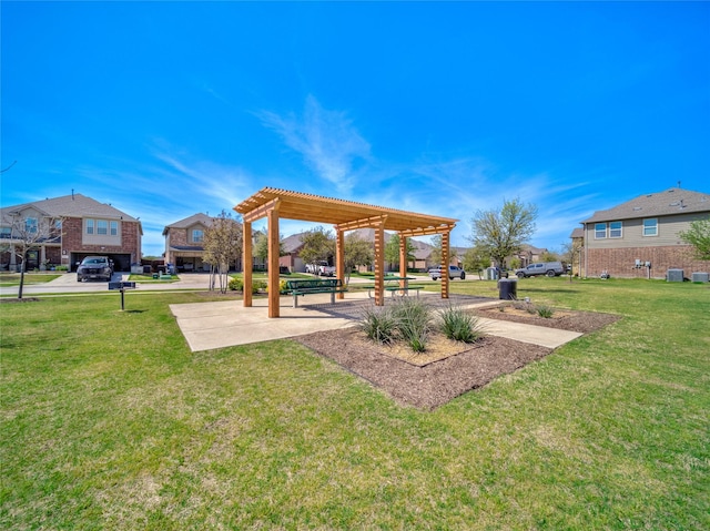 view of yard with a pergola and a residential view