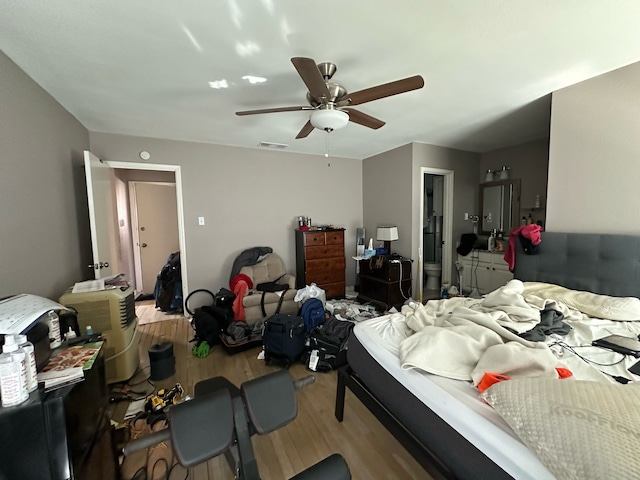 bedroom with visible vents, a ceiling fan, and wood finished floors