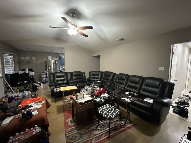 living area with visible vents, ceiling fan, wood finished floors, and vaulted ceiling