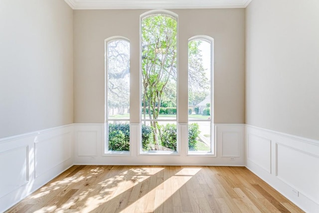 4908 Meandering Way, Colleyville, TX 76034 - unfurnished room featuring a wainscoted wall, light wood-type flooring, ornamental molding, and a decorative wall