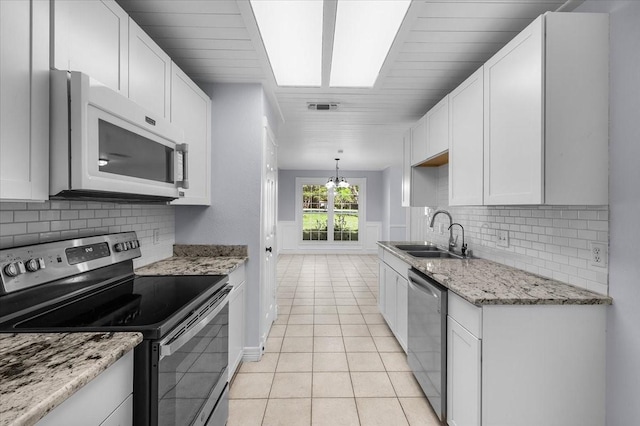 120 Southwinds Dr, Weatherford, TX 76087 - kitchen with light tile patterned floors, visible vents, appliances with stainless steel finishes, a sink, and backsplash
