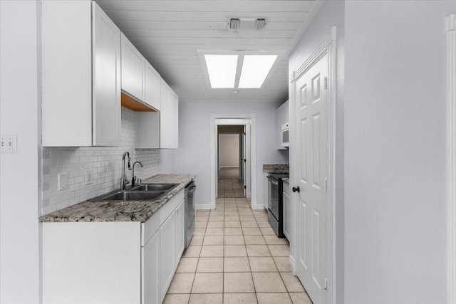 120 Southwinds Dr, Weatherford, TX 76087 - kitchen featuring stainless steel dishwasher, black electric range, a sink, decorative backsplash, and baseboards